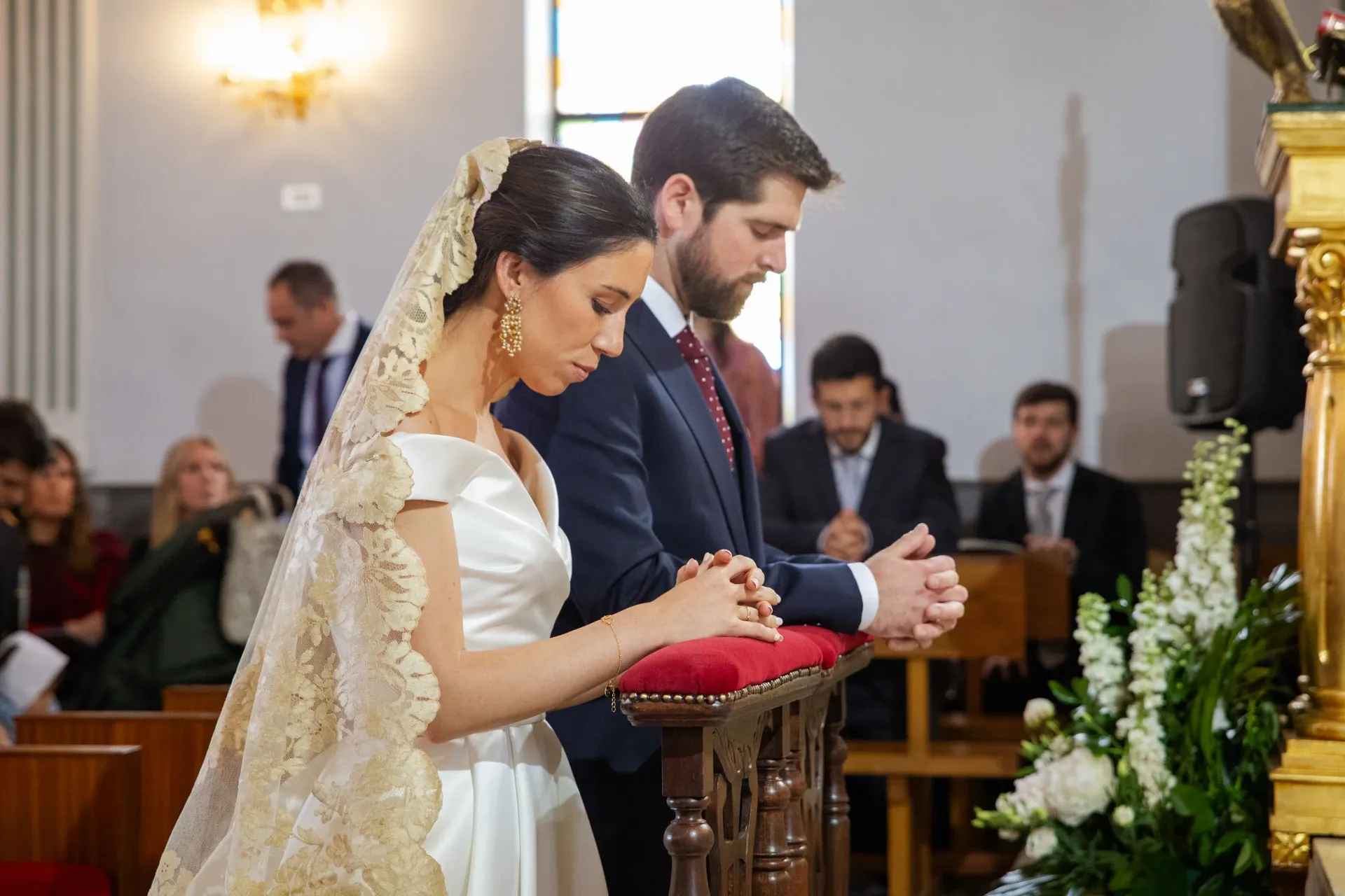 Novios arrodillados durante la ceremonia religiosa