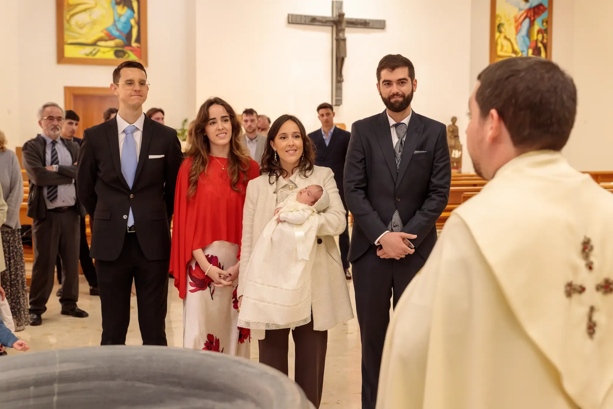 Familia y padrinos en la iglesia durante el bautizo