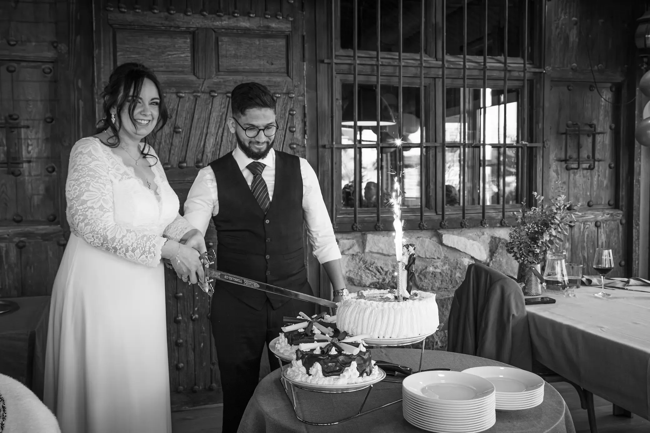 Novios cortando la tarta de boda, en blanco y negro