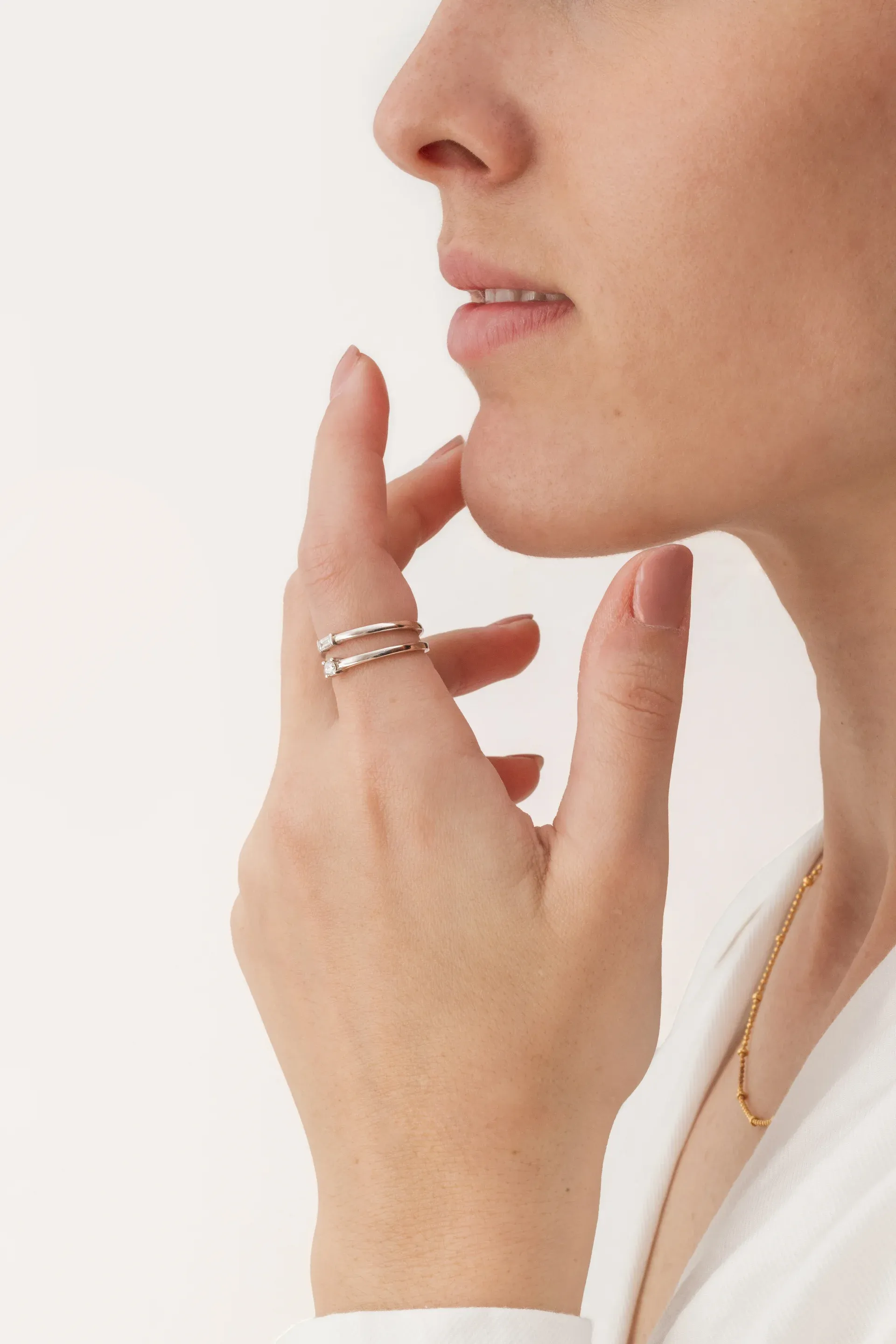 Modelo luciendo anillos finos, fotografía de joyería